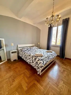 a bedroom with a bed and a chandelier at Casa Vittoria Stadio olimpico con panorama in Rome