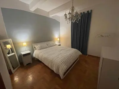 a small bedroom with a bed and a chandelier at Casa Vittoria Stadio olimpico con panorama in Rome