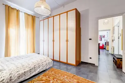 a bedroom with a bed and a large closet at Termini Sweet Home in Rome