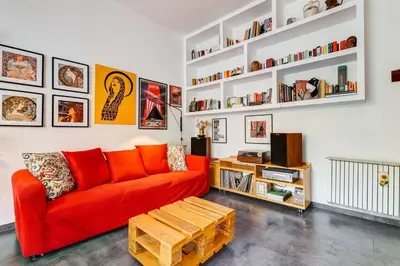 a living room with a red couch and a wooden coffee table at Termini Sweet Home in Rome