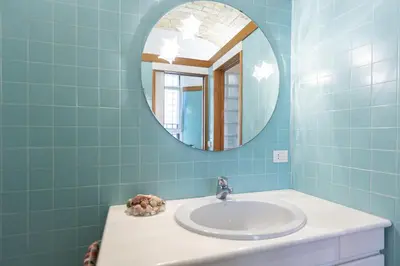a bathroom with a sink and a mirror at San Gioacchino View by Rental in Rome in Rome