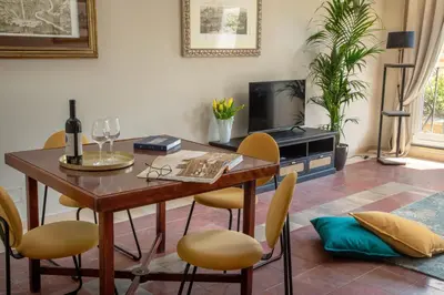 a dining room with a wooden table and chairs at Daplace - Arianna Apartment in Rome