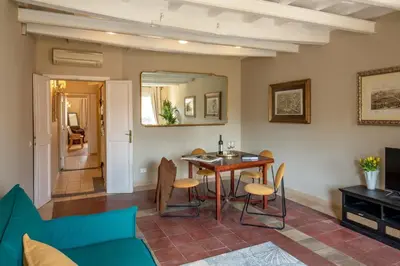 a living room with a table and chairs at Daplace - Arianna Apartment in Rome