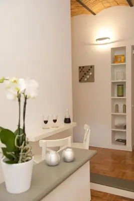 a kitchen with a table with two glasses of wine at Vatican Charme in Rome