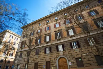 a large brick building with a door in front of it at Vatican Charme in Rome