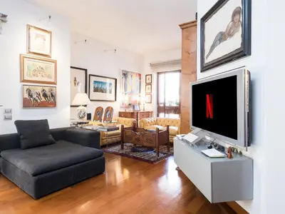 a living room with a tv and a couch at Marisol's House, Colosseo in Rome