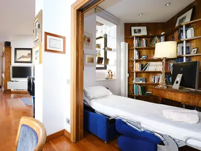 a room with a bed and bookshelves at Marisol's House, Colosseo in Rome