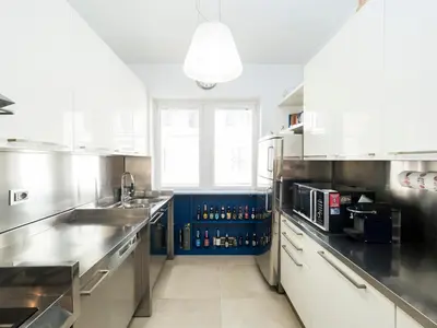 a large kitchen with white cabinets and a sink at Marisol's House, Colosseo in Rome