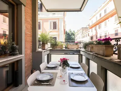a table and chairs on a balcony with a view at Marisol's House, Colosseo in Rome