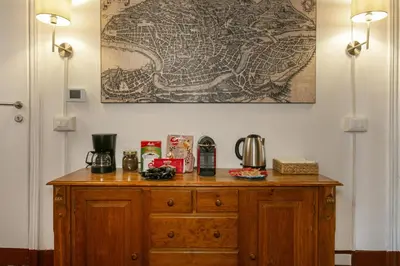 a wooden dresser in a room with a picture on the wall at Pantheon Palazzo Nari #9 in Rome