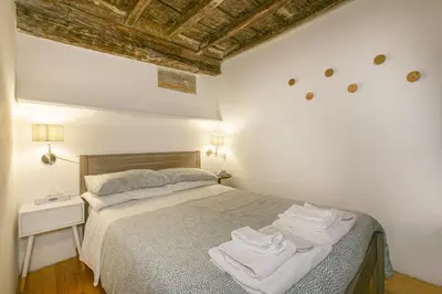 a bedroom with a bed with towels on it at Pantheon Palazzo Nari #9 in Rome