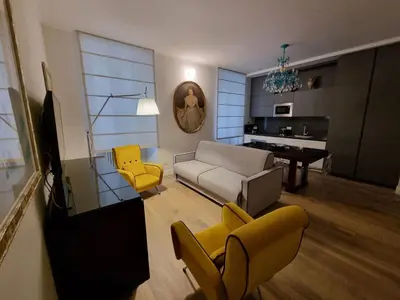 a living room with a couch and yellow chairs at A casa di Marisa in Rome
