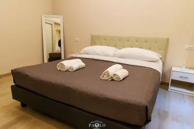 a bedroom with a bed with two towels on it at Domus Degli Dei in Rome