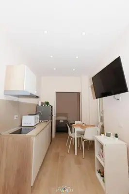a kitchen with a counter and a table with a dining room at Domus Degli Dei in Rome