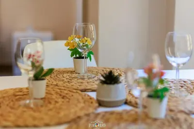 a table with wine glasses and potted plants on it at Domus Degli Dei in Rome