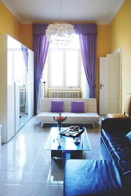 a living room with purple curtains and a couch at Bed and Breakfast Piazza Vittorio87 in Rome