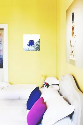 a bedroom with two white beds with colorful pillows at Bed and Breakfast Piazza Vittorio87 in Rome
