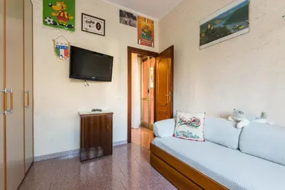 a living room with a couch and a flat screen tv at family home in Rome