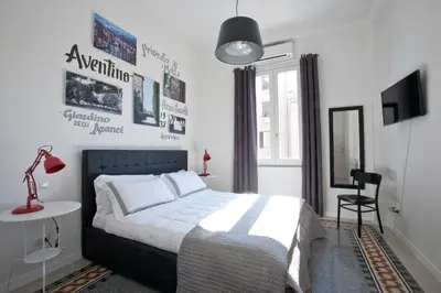 a bedroom with a bed and a table and a chair at Saint Peter's Keys in Rome