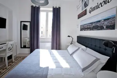 a bedroom with a bed and a desk and a window at Saint Peter's Keys in Rome