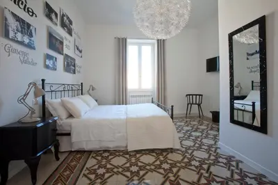 a bedroom with a white bed and a mirror at Saint Peter's Keys in Rome