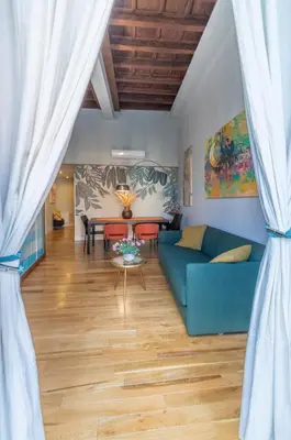 a living room with a blue couch and a table at Navona Charming Balcony in Rome