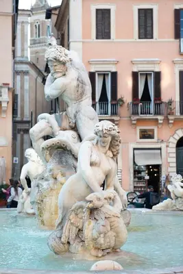 a statue in a fountain in front of a building at Navona Charming Balcony in Rome