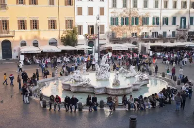 a crowd of people standing around a fountain in a city at Navona Charming Balcony in Rome