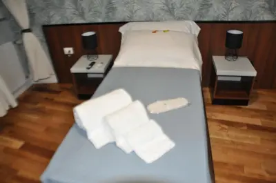 a bed with two night stands and white towels on it at Navona Charming Balcony in Rome
