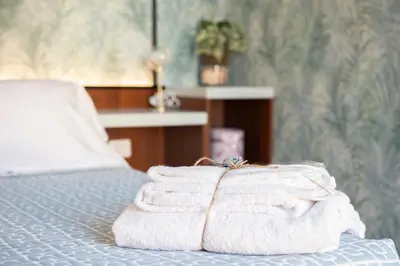 a pile of towels sitting on top of a bed at Navona Charming Balcony in Rome
