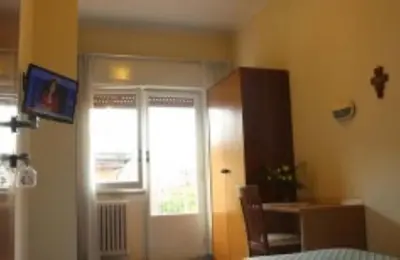 a room with a door and a table and a window at Casa Piccole Ancelle di Cristo Re in Rome