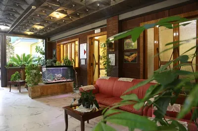 a living room with a red couch and a tv at Casa Piccole Ancelle di Cristo Re in Rome