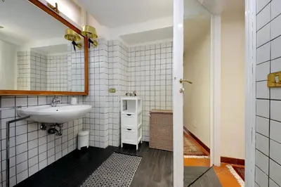 a bathroom with a sink and a mirror at Leonina4 Cozy Apartment in Rome
