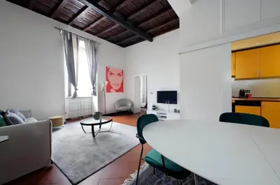 a living room with a white table and chairs at Leonina4 Cozy Apartment in Rome