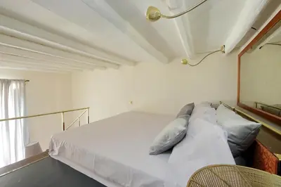 a bedroom with a bed with white sheets and pillows at Leonina4 Cozy Apartment in Rome