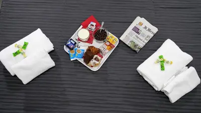 a table with a plate of food and napkins at Tiburtina Royal Suites in Rome