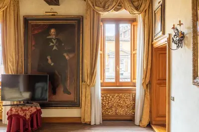a room with a painting of a man on the wall at iFlat Golden Gem in Trevi in Rome