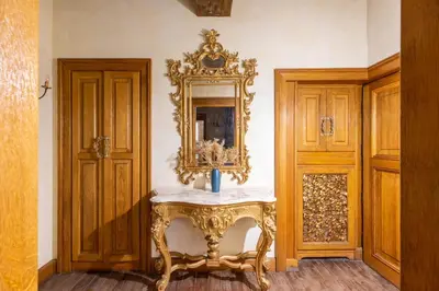 an ornate table with a mirror on a wall at iFlat Golden Gem in Trevi in Rome