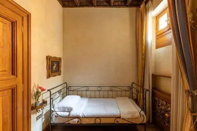 a small bedroom with a bed in a room at iFlat Golden Gem in Trevi in Rome