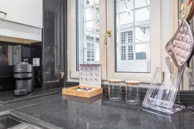 a kitchen with a counter with two vases on it at Trastevere San Calisto 3 BDR Apartment in Rome