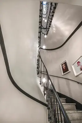 a spiral staircase in a building with pictures on the walls at Corso 281 Luxury Suites in Rome