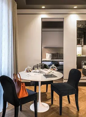 a dining room with a table and two chairs at Corso 281 Luxury Suites in Rome
