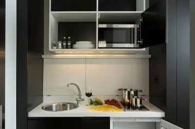 a kitchen counter with a sink and a microwave at Corso 281 Luxury Suites in Rome