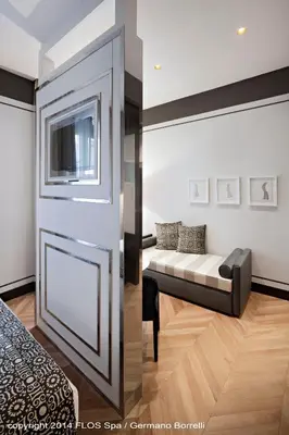 a living room with a couch next to a door at Corso 281 Luxury Suites in Rome