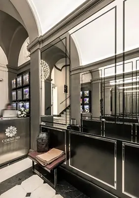 a dressing room with a bench and a mirror at Corso 281 Luxury Suites in Rome