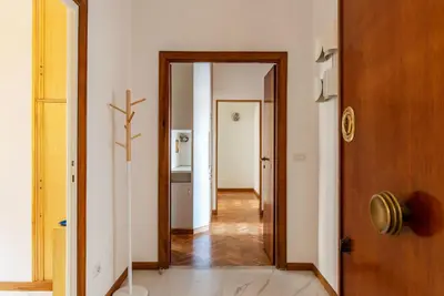 a hallway with a door leading into a room at GuestHost - Sapienza & Villa Borghese Comfy Apartment in Rome