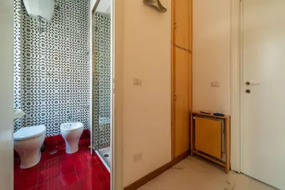 a bathroom with a toilet and a shower at GuestHost - Sapienza & Villa Borghese Comfy Apartment in Rome