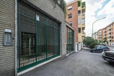 a building with bars on the side of a street at GuestHost - Sapienza & Villa Borghese Comfy Apartment in Rome