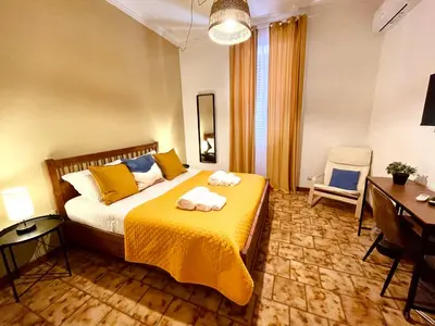 a bedroom with a large bed and a blue wall at Monteverde Hideaway in Rome