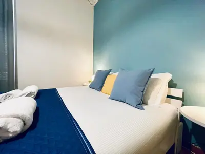 a bedroom with a bed and a desk and a chair at Monteverde Hideaway in Rome